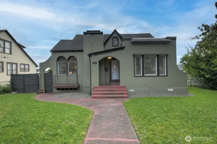 Timeless 1920 stucco home featuring distinctive architectural character, arched details, and inviting curb appeal in the heart of Chehalis. Spacious front lawn and classic design create a warm welcome from the moment you arrive.