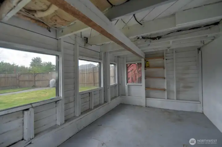 Versatile enclosed storage and workshop space with built-in shelving and easy backyard access—ideal for hobbies, tools, seasonal storage, or future creative use.