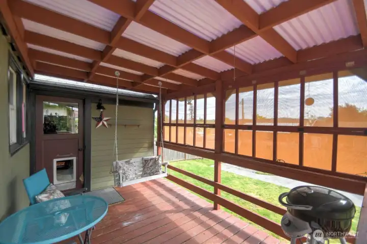Covered outdoor living at its best! This inviting patio features a cozy porch swing, plenty of space to relax or entertain, and removable covered panels that can be hung up or opened for added flexibility and seasonal enjoyment.