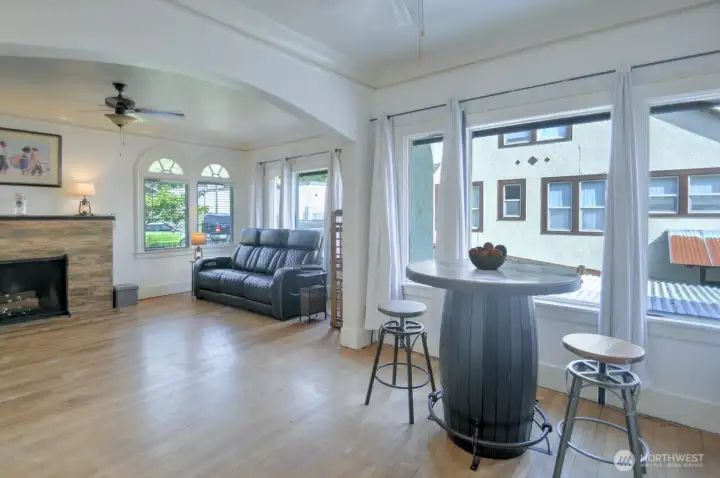 Bright and airy living and dining spaces featuring large windows, beautiful hardwood floors, and timeless character throughout.
