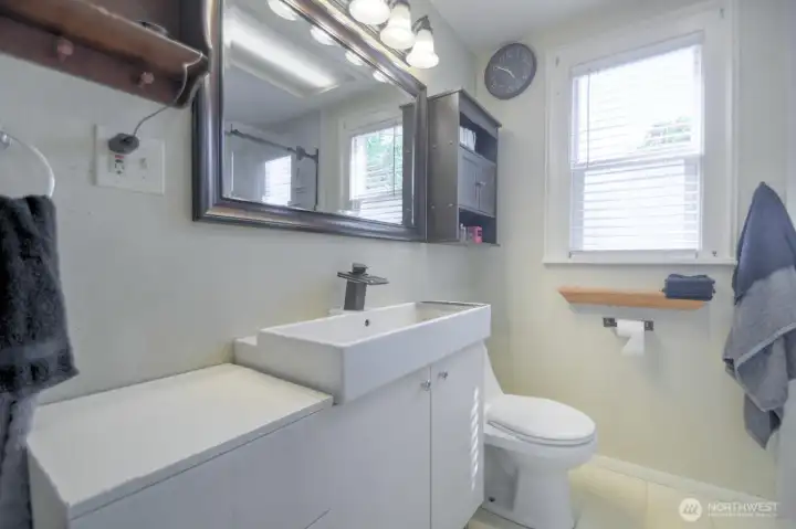 Tastefully updated bathroom with modern lighting, stylish fixtures, and a clean, bright design that offers both comfort and functionality.