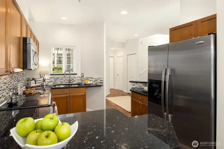 Looking from the breakfast bar towards the kitchen and the entry to the home.