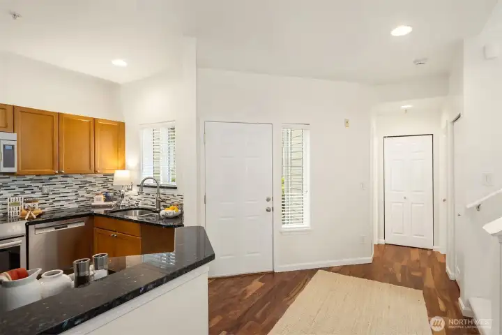 The hallway to the left of the front door leads to the main-level powder room, pantry, and laundry room. It is through the laundry room that you will reach your 2-car garage, again with no stairs.