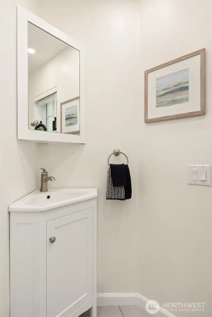 The main-level powder room is tucked away for privacy because not everything needs to be shared.