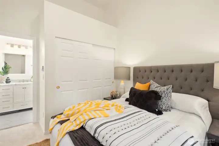 A view of the second bedroom's closet and access to its private, full bath.