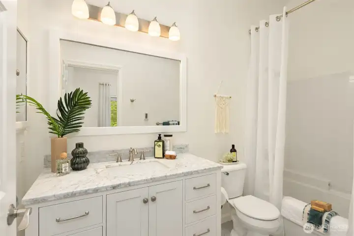 The full bath has heated flooring and a skylight to let in natural sunlight.