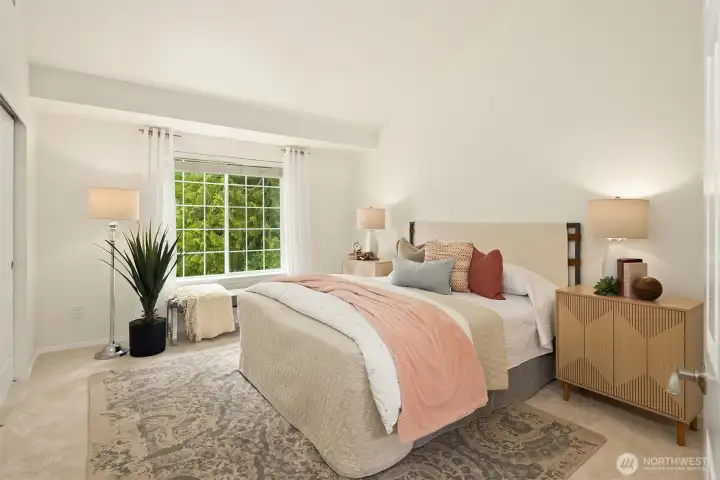 The primary bedroom is spacious and has an entire wall of closets across from the bed.