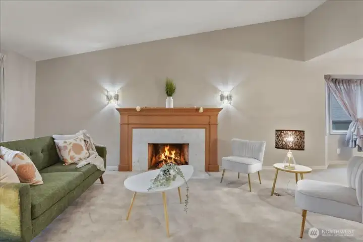carpeted living room, gas fireplace, vaulted ceiling, wall sconces carpeted living room, gas fireplace, vaulted ceiling, wall sconces