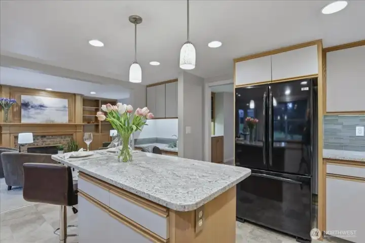 upgraded kitchen, island, vinyl flooring, free-standing fridge upgraded kitchen, island, vinyl flooring, free-standing fridge