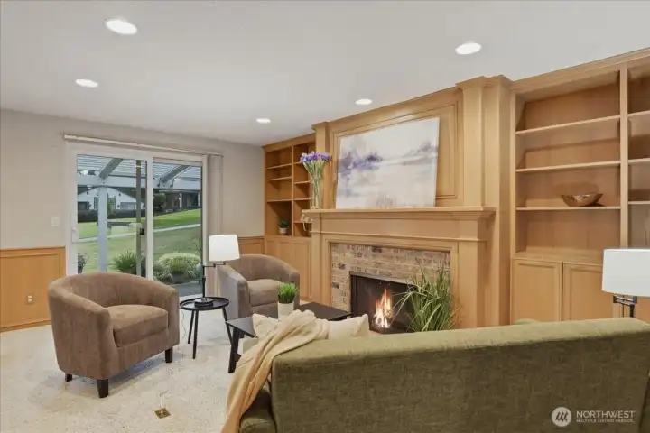 family room, carpeted, gas fireplace, built-in shelves, wainscoting, wood, patio access, sliding door, golf course view family room, carpeted, gas fireplace, built-in shelves, wainscoting, wood, patio access, sliding door, golf course view