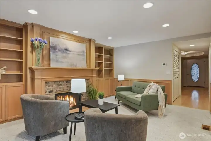 carpeted family room, great room design, gas fireplace, built-in shelvews, wainscoting, wood carpeted family room, great room design, gas fireplace, built-in shelvews, wainscoting, wood