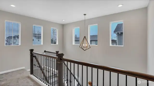 Upstairs opens to the front entry with wall of windows providing ample natural light.