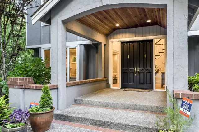 As you approach the cedar lined covered front entry double doors open into the voluminous foyer.