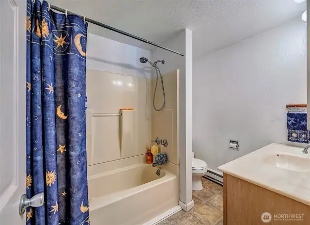 Full bathroom with a one piece tub surround