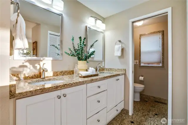 Refreshed primary drive back with dual vanities and shower.