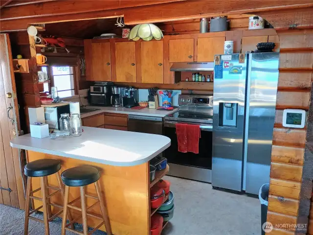 Kitchen with updated appliances and eating bar
