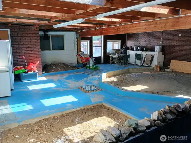 Large enclosed area with skylights and access to family room and patio