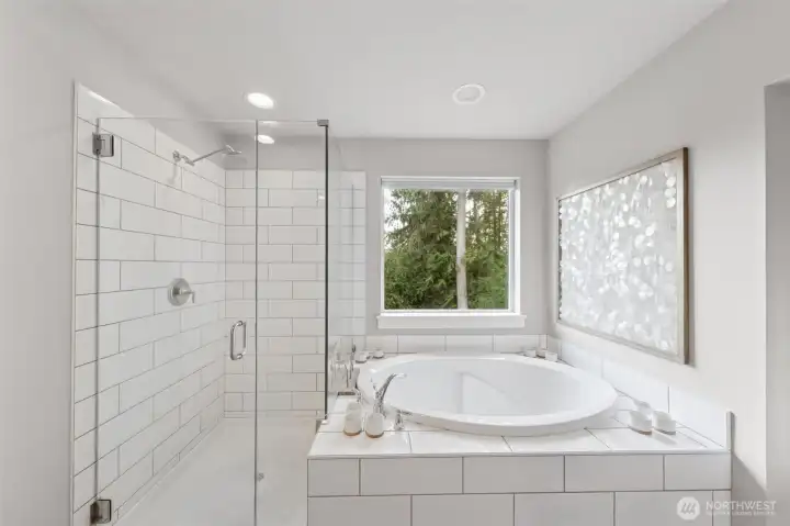 Soaking tub and glass shower with beautiful private view