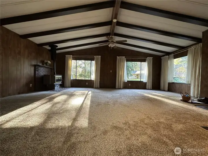The living room is very large with lots of natural light.