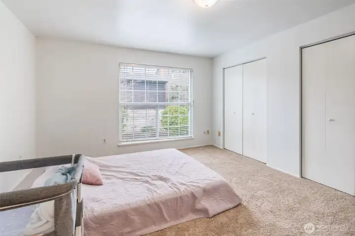 Very large primary bedroom with two closet spaces.