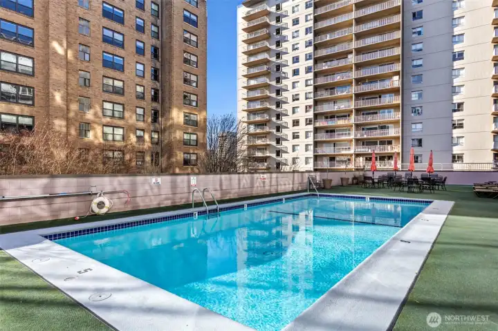 The gated outdoor pool and sun deck—with tables and seating—is an easy place to spend a sunny afternoon.