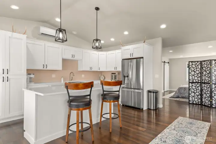MIL Kitchen area with island and quartz countertops