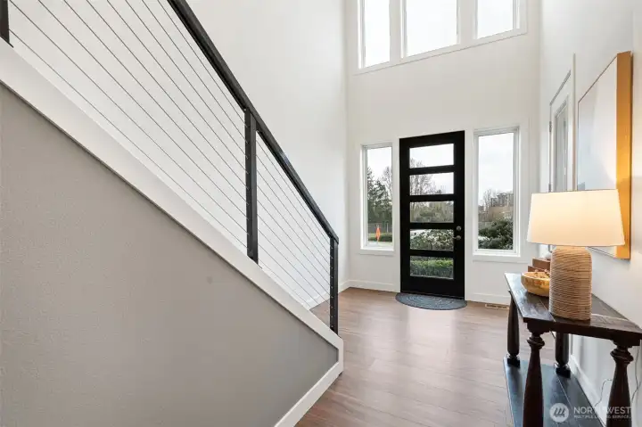 A welcoming entry with soaring ceilings and abundant windows that fill the space with natural light.