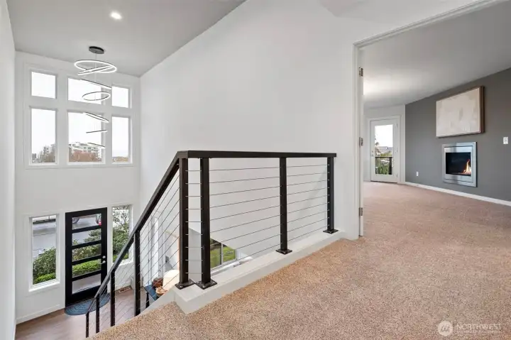 The second-floor landing also enjoys the beautiful natural light from the entry’s expansive windows.natural light
