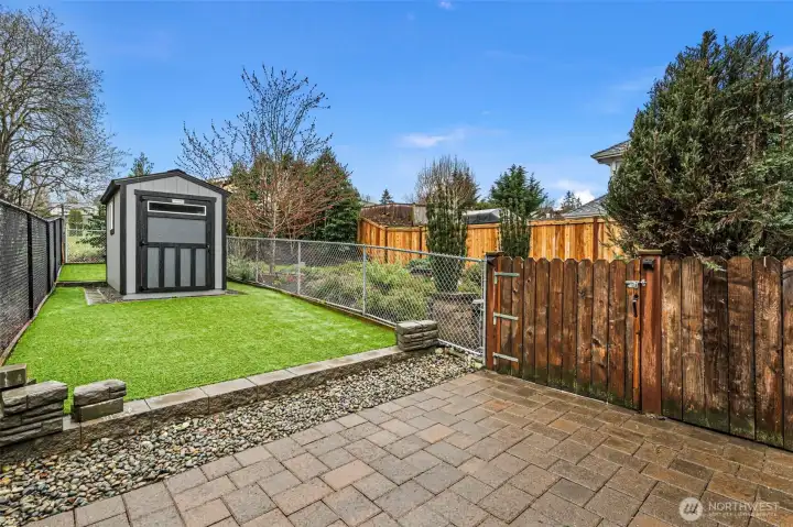 Plenty of hardscape to enjoy along with some low maintenance turf and bonus storage!