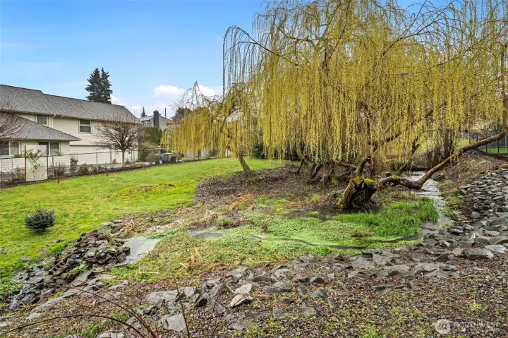 It is an outdoor retreat that perfectly blends natural serenity with the breathtaking beauty of the waterfront beyond.