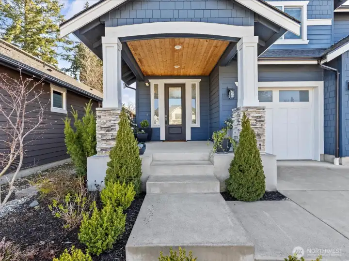 Inviting covered entry porch with cedar soffit ceiling