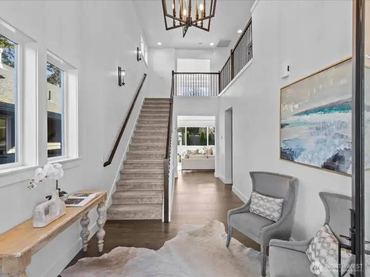 Grand two story entry foyer with pendant chandelier