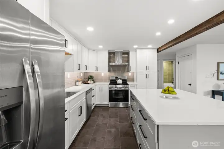 The large island and ample storage are complimented by stainless steel appliances.