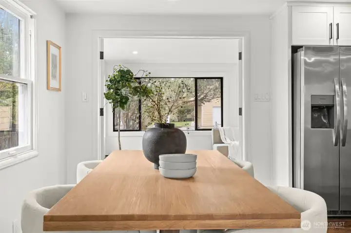 Dining area flows from living room into the sun room.