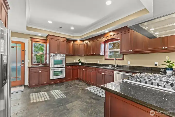Kitchen with separate entrance leading up from garage.