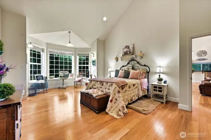 Main floor Primary suite is a retreat!!  You will love these vaulted ceilings and the rounded bay window~