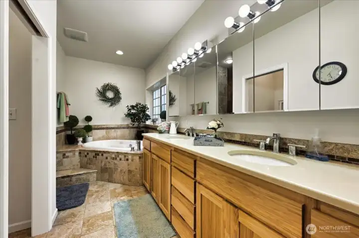 Soothe away your day in this air-bubble jetted tub-lovely hickory cabinets and quartz counters.  Not to mention a walk-in closet and shower to the left!