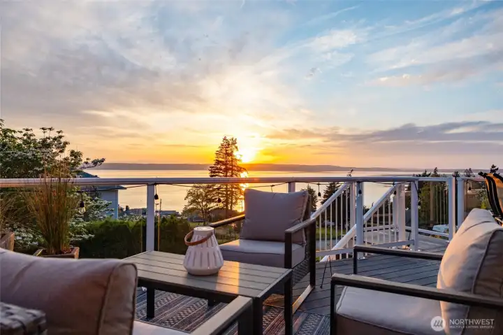 Your new view - all day, every day.  Western exposure gives you year-round sunsets from the composite deck that runs the full length of the home.  Look out over Port Susan, Warm Beach, and Camano Island, with the Olympics in the background.