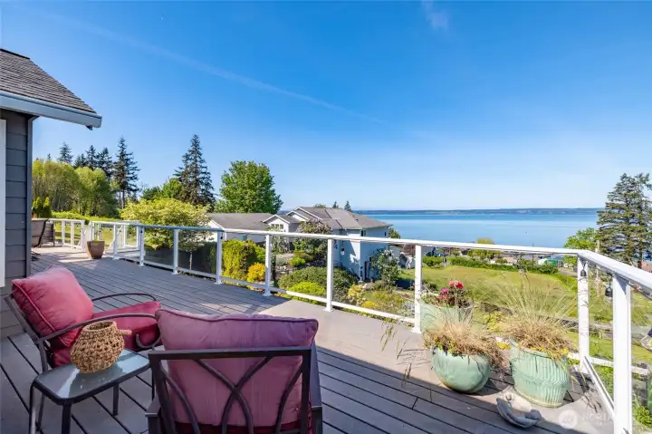 Seating area outside the primary suite - watch boats, eagles, and even whales from your deck. Empty lots below are designated septic drainfields and/or otherwise not buildable (buyer to verify), so your view is preseved.
