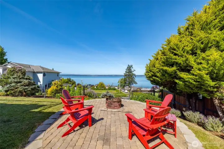 Just one of several outdoor entertaining areas, the firepit patio has stunning water views, lots of afternoon sun, while the tree at right gives some evening shade.