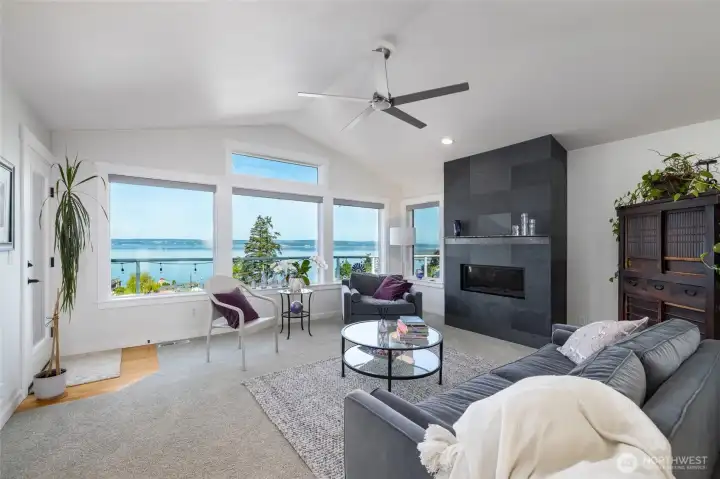 This is the view that greets you and your guests every time the front door opens.  Welcome home!  This home has undergone a complete transformation/renovation, including new windows, flooring, lights, and this sleek, moody fireplace surround.  Windows face the incredible water and Camano Island views. A French door leads from the living room to the deck.