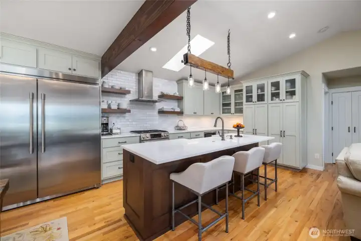 A full-sized refrigerator and full-size freezer sit side-by-side in this gorgeous kitchen.  Premium materials and appliances make both daily living and holiday entertaining feel special.