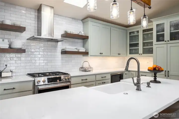Full height back splash and cabinets, new skylights enhance the feeling of light and spaciousness in the kitchen.
