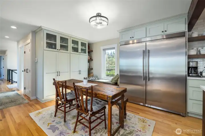 The breakfast area sits inside the kitchen and offers a casual space for family and friends to dine and gather. Built-in pantry and storage and a window seat bring a warm, inviting vibe to this space.