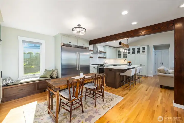 A view of the kitchen from the breakfast area, with window seat (and additional storge) at left.