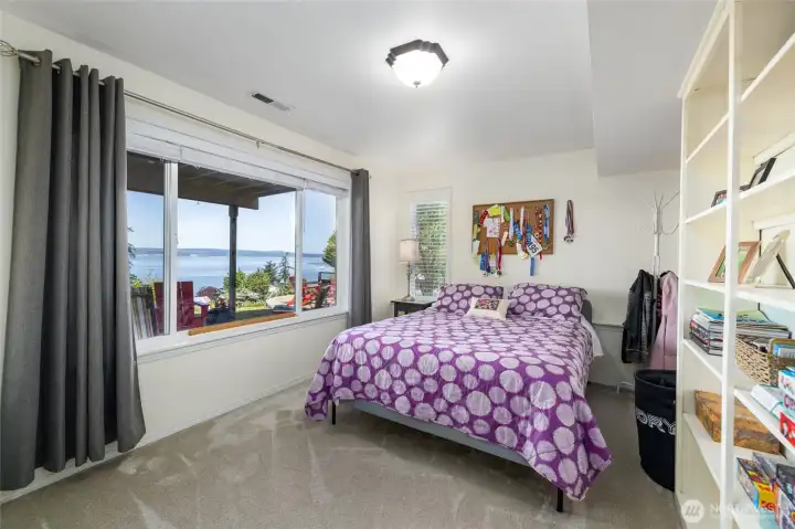 Lower floor bedroom with breathtaking water views and sheltered patio right outside.