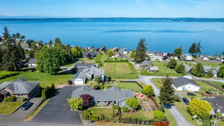 An aerial shot of the home, showing its ideal location with unobstructed water views.