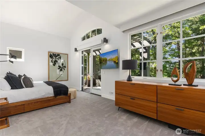 The primary with French doors leading to a private deck. The primary with French doors leading to a private deck.