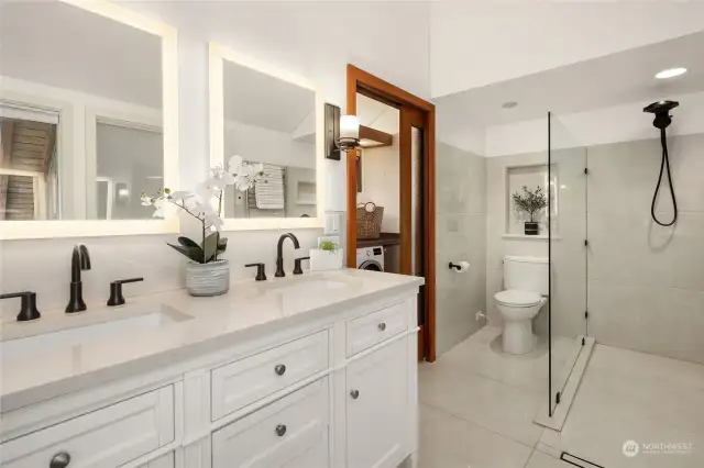 The luxurious ensuite bathroom features a double vanity, curbless entry walk-in shower and radiant heated floor