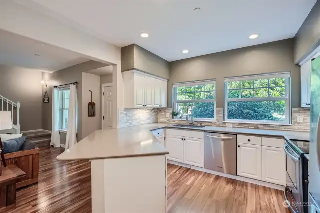 The overhang is perfect to put stools under! You will love the full height backsplash & under counter lighting